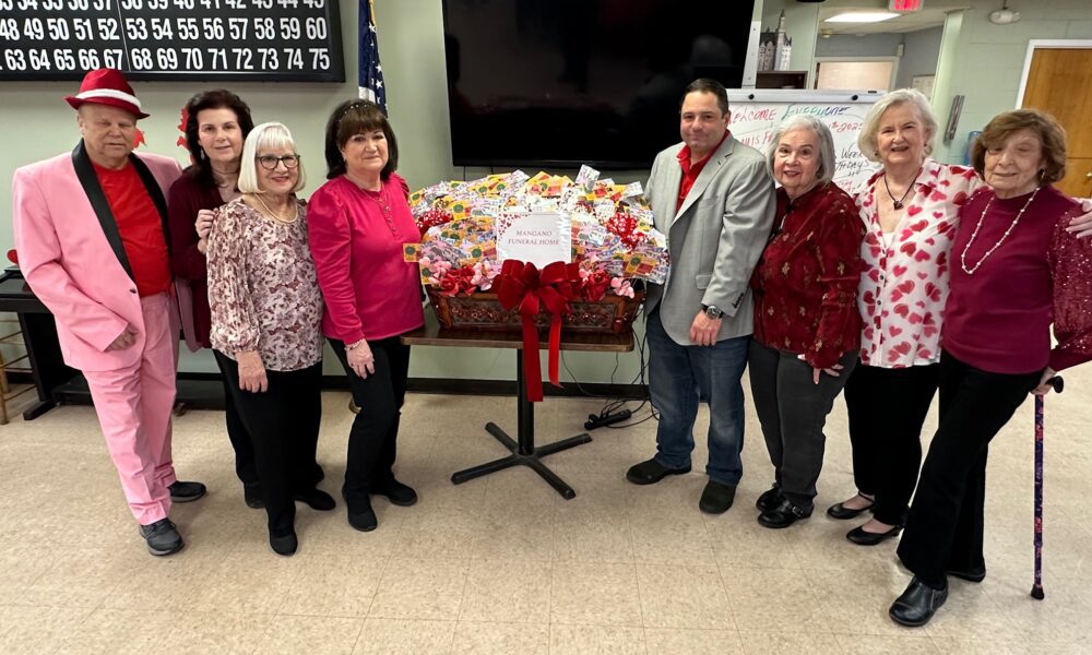 Sal Mangano, President of Mangano Family Funeral Homes, donates scratch-off lottery tickets to seniors at the Spangle Drive Senior Center in North Babylon during their Valentine’s Day celebration.