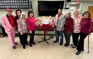 Sal Mangano, President of Mangano Family Funeral Homes, donates scratch-off lottery tickets to seniors at the Spangle Drive Senior Center in North Babylon during their Valentine’s Day celebration.