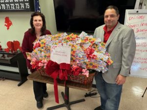 : Sal Mangano, President of Mangano Family Funeral Homes, pictured here with Carolyn Epifane, Director of the Spangle Drive Senior Center in North Babylon, proudly donates scratch-off lottery tickets at the center’s Valentine’s Day celebration.